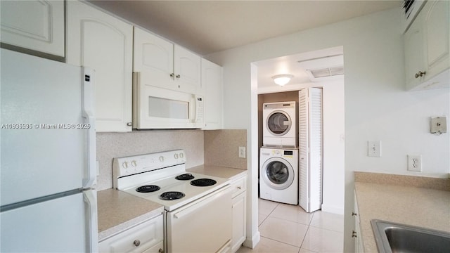8100 Geneva Ct Unit 343, Doral, FL 33166 - kitchen featuring white appliances, stacked washing machine and dryer, light countertops, and white cabinetry