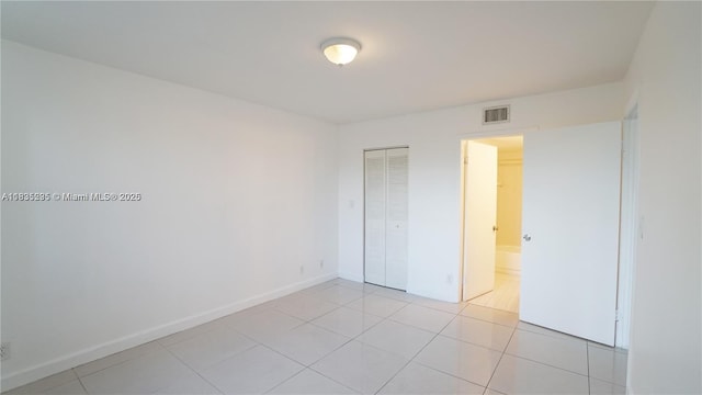 8100 Geneva Ct Unit 343, Doral, FL 33166 - unfurnished bedroom featuring a closet and light tile patterned floors