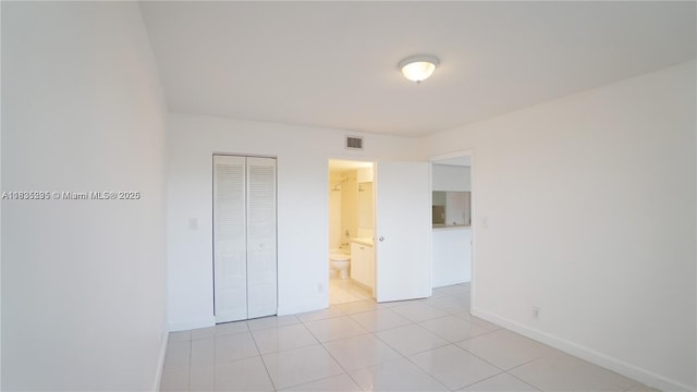 8100 Geneva Ct Unit 343, Doral, FL 33166 - unfurnished bedroom featuring ensuite bath, a closet, and light tile patterned floors