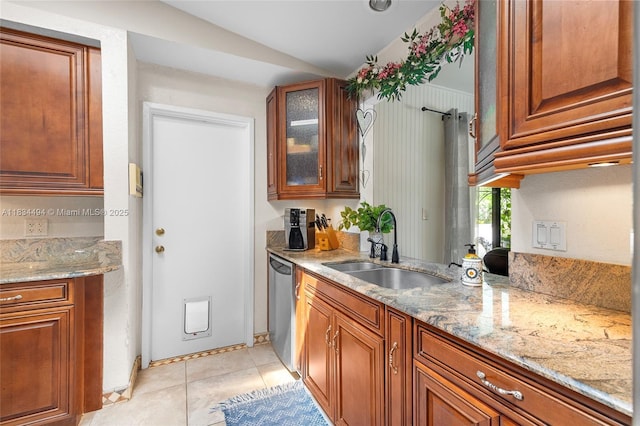 5001 SW 11th Cir, Margate, FL 33068 - kitchen with dishwasher, light stone counters, brown cabinets, lofted ceiling, and glass insert cabinets