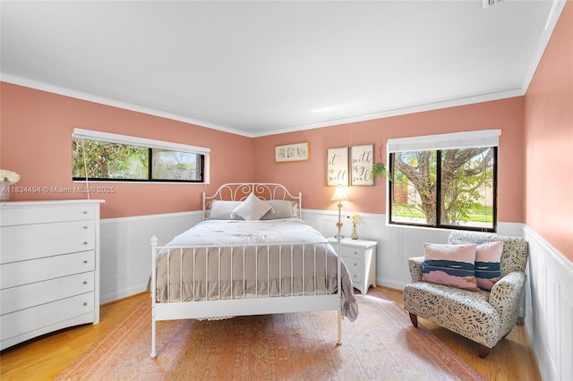 5001 SW 11th Cir, Margate, FL 33068 - bedroom with a wainscoted wall, multiple windows, light wood-style flooring, and crown molding
