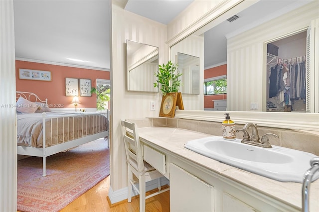 5001 SW 11th Cir, Margate, FL 33068 - bathroom featuring vanity, wood finished floors, ornamental molding, and ensuite bath