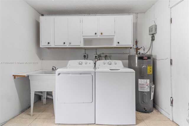 5001 SW 11th Cir, Margate, FL 33068 - washroom featuring water heater, cabinet space, washer and dryer, and light tile patterned flooring