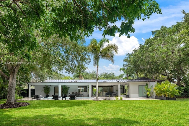 15121 SW 69th Ct, Palmetto Bay, FL 33158 - back of house featuring ceiling fan, a standing seam roof, and stucco siding