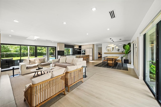 15121 SW 69th Ct, Palmetto Bay, FL 33158 - living area featuring recessed lighting, a skylight, and light wood-style floors