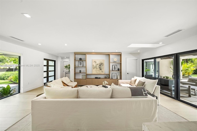 15121 SW 69th Ct, Palmetto Bay, FL 33158 - living room with french doors, light wood-type flooring, a skylight, and recessed lighting