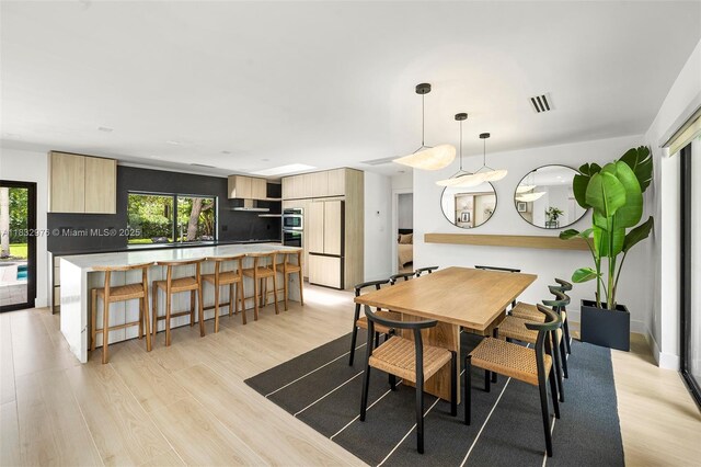 15121 SW 69th Ct, Palmetto Bay, FL 33158 - dining space with light wood-style floors and healthy amount of natural light