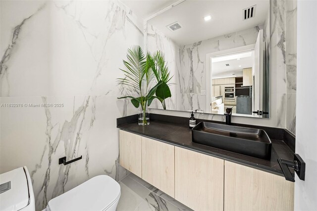 15121 SW 69th Ct, Palmetto Bay, FL 33158 - half bath featuring vanity, tile walls, marble finish floors, and recessed lighting