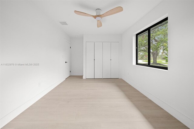 15121 SW 69th Ct, Palmetto Bay, FL 33158 - unfurnished bedroom featuring a closet, a ceiling fan, and light wood-style floors