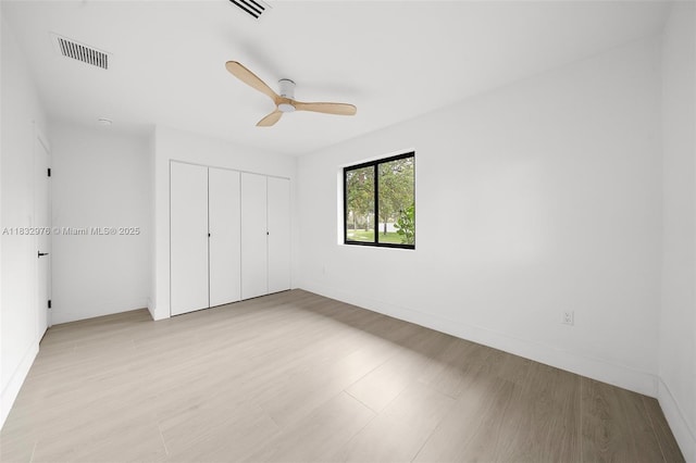 15121 SW 69th Ct, Palmetto Bay, FL 33158 - unfurnished bedroom with a closet, light wood-style floors, and ceiling fan