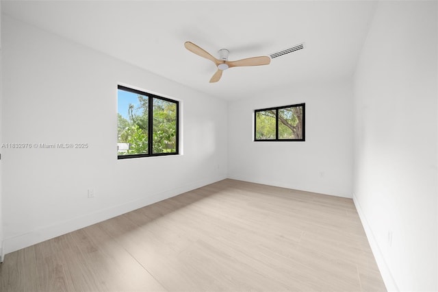 15121 SW 69th Ct, Palmetto Bay, FL 33158 - unfurnished room featuring healthy amount of natural light, light wood-style floors, and a ceiling fan