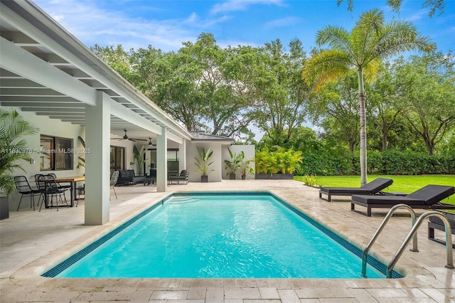 15121 SW 69th Ct, Palmetto Bay, FL 33158 - outdoor pool with a ceiling fan, a patio area, and view of wooded area