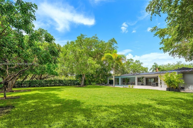 15121 SW 69th Ct, Palmetto Bay, FL 33158 - view of green lawn featuring a patio area
