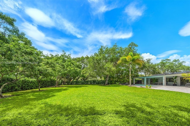 15121 SW 69th Ct, Palmetto Bay, FL 33158 - view of green lawn featuring a patio area