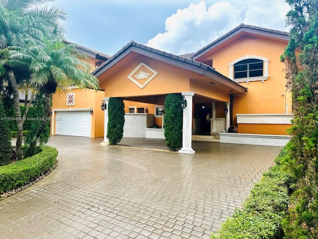 8565 NW 168th Ter, Miami Lakes, FL 33016 - view of front facade with driveway, stucco siding, a garage, and a tile roof
