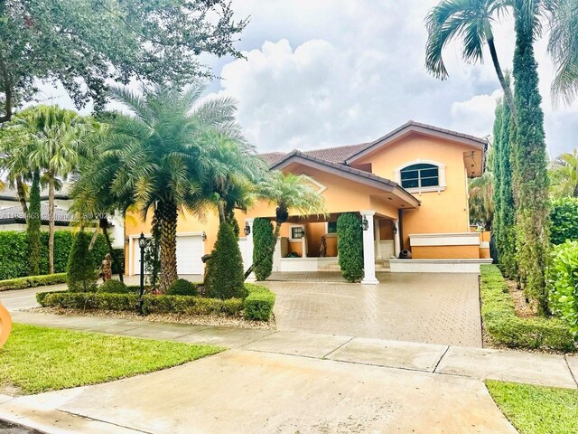 8565 NW 168th Ter, Miami Lakes, FL 33016 - view of front facade with stucco siding and driveway