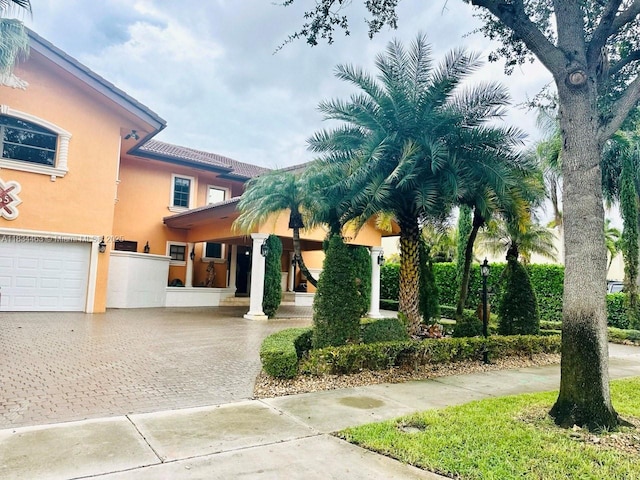 8565 NW 168th Ter, Miami Lakes, FL 33016 - view of front facade with driveway, stucco siding, and a garage
