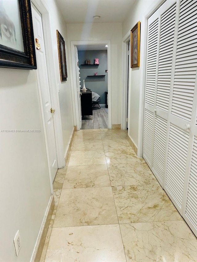 8565 NW 168th Ter, Miami Lakes, FL 33016 - hallway featuring light marble finish floors and baseboards