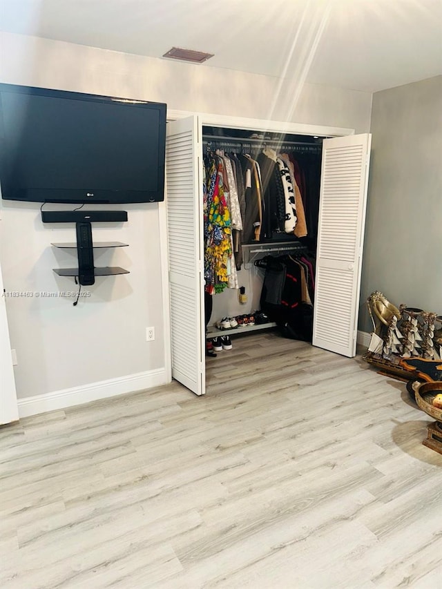 8565 NW 168th Ter, Miami Lakes, FL 33016 - bedroom featuring wood finished floors and a closet