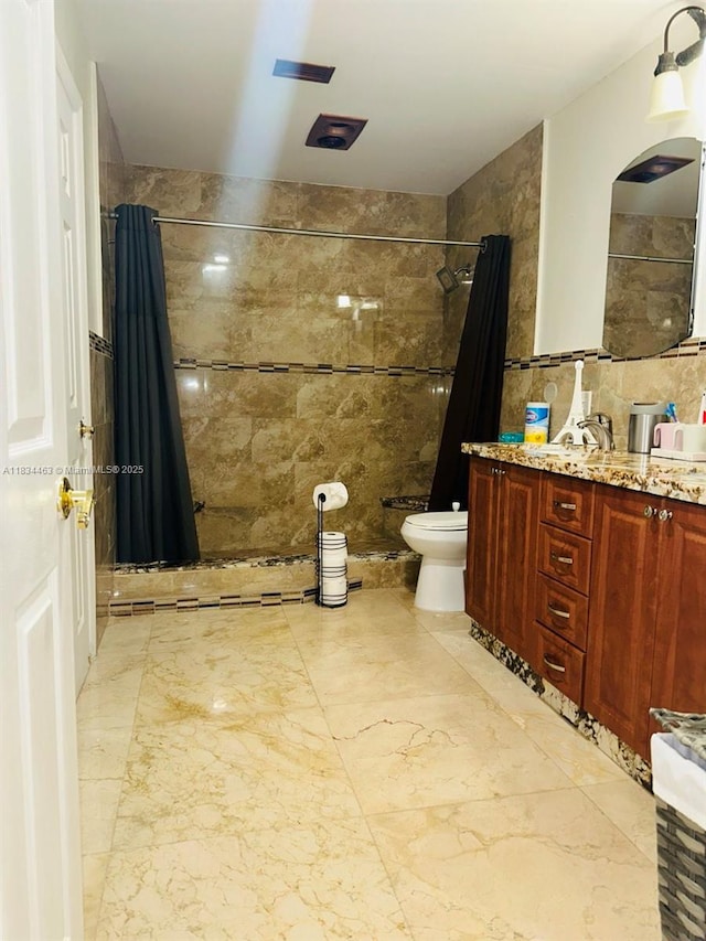 8565 NW 168th Ter, Miami Lakes, FL 33016 - bathroom with tile walls, tiled shower, double vanity, and marble finish floors