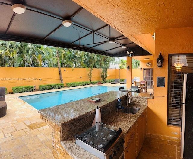 8565 NW 168th Ter, Miami Lakes, FL 33016 - view of swimming pool featuring a fenced backyard, exterior kitchen, and a patio