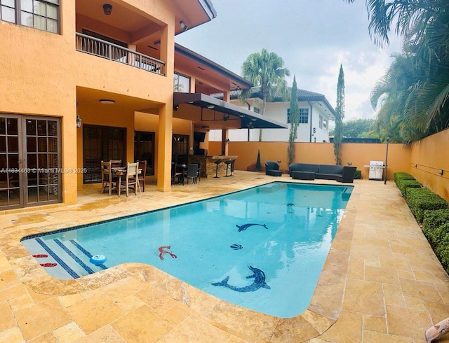 8565 NW 168th Ter, Miami Lakes, FL 33016 - view of swimming pool with a patio area, a fenced backyard, french doors, and outdoor lounge area
