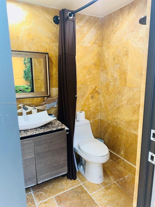 8565 NW 168th Ter, Miami Lakes, FL 33016 - bathroom featuring vanity, tile walls, stone finish floors, and a shower with curtain