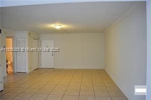 2201 NW 41st Ave Unit 108, Lauderhill, FL 33313 - tiled spare room with ornamental molding