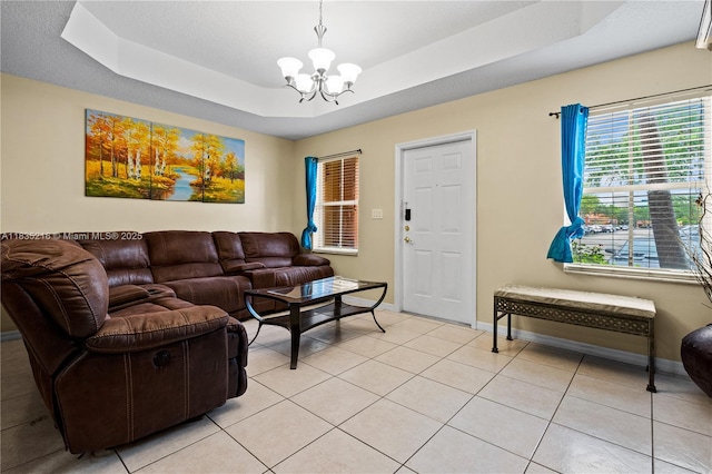 604 SW 107th Ave Unit 706, Pembroke Pines, FL 33025 - living area featuring a chandelier, a raised ceiling, and light tile patterned flooring
