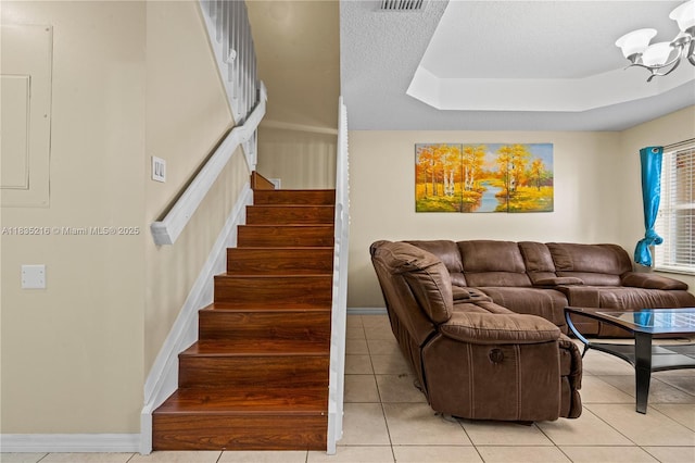 604 SW 107th Ave Unit 706, Pembroke Pines, FL 33025 - living area featuring stairs, light tile patterned flooring, a tray ceiling, and a textured ceiling