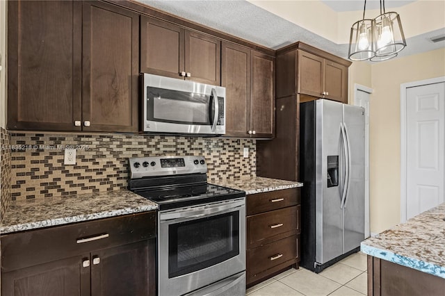604 SW 107th Ave Unit 706, Pembroke Pines, FL 33025 - kitchen with stainless steel appliances, decorative backsplash, dark brown cabinetry, and light tile patterned floors