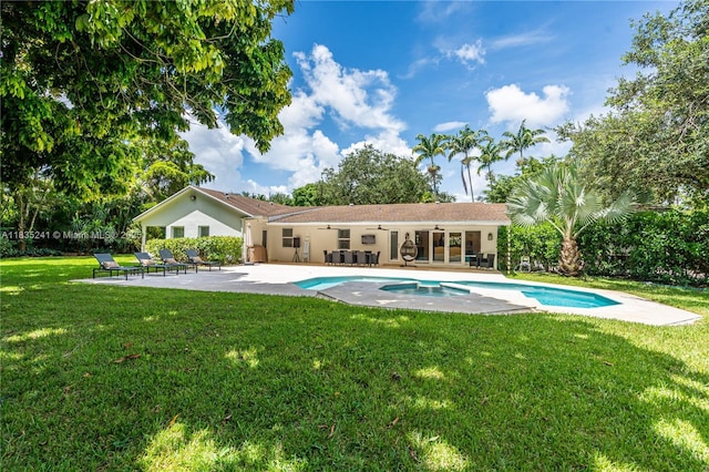 10821 SW 92nd Ave, Miami, FL 33176 - swimming pool featuring a ceiling fan, a patio, a lawn, and an in-ground hot tub
