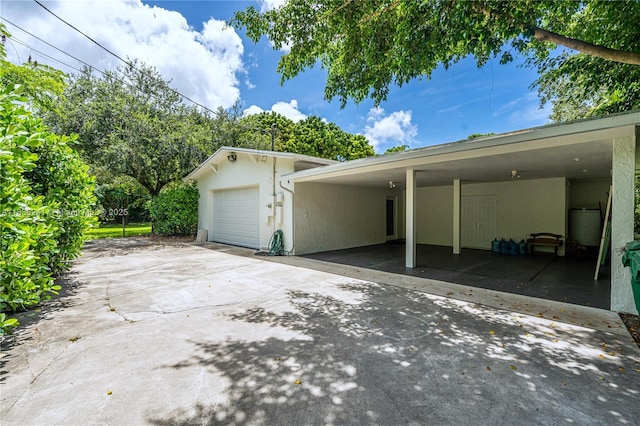 10821 SW 92nd Ave, Miami, FL 33176 - view of side of property with stucco siding, concrete driveway, and a garage