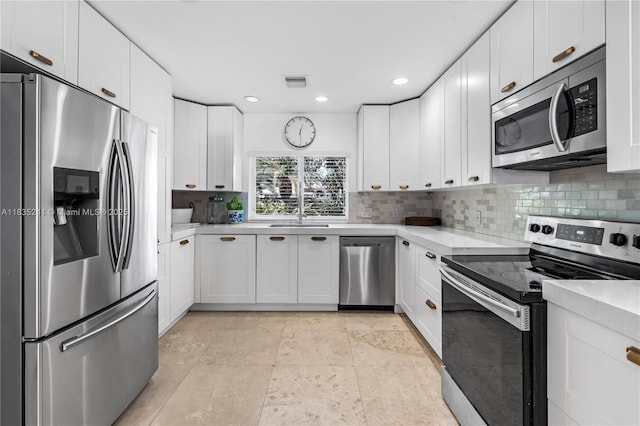 10821 SW 92nd Ave, Miami, FL 33176 - kitchen with appliances with stainless steel finishes, decorative backsplash, light countertops, white cabinetry, and recessed lighting
