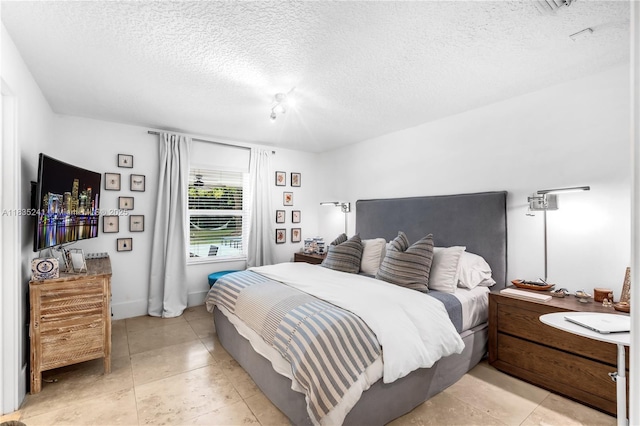 10821 SW 92nd Ave, Miami, FL 33176 - bedroom with a textured ceiling and light tile patterned floors