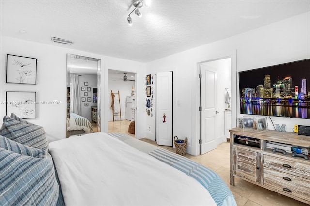 10821 SW 92nd Ave, Miami, FL 33176 - bedroom featuring light tile patterned flooring, a textured ceiling, and track lighting