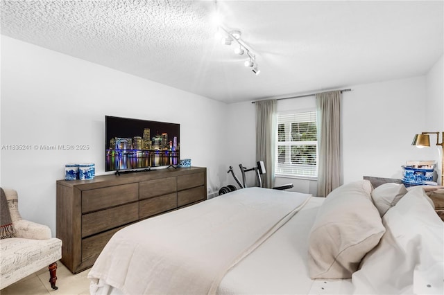 10821 SW 92nd Ave, Miami, FL 33176 - bedroom with track lighting, tile patterned flooring, and a textured ceiling