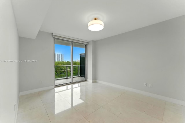 16385 Biscayne Blvd Unit 301, North Miami Beach, FL 33160 - spare room with floor to ceiling windows and light tile patterned flooring