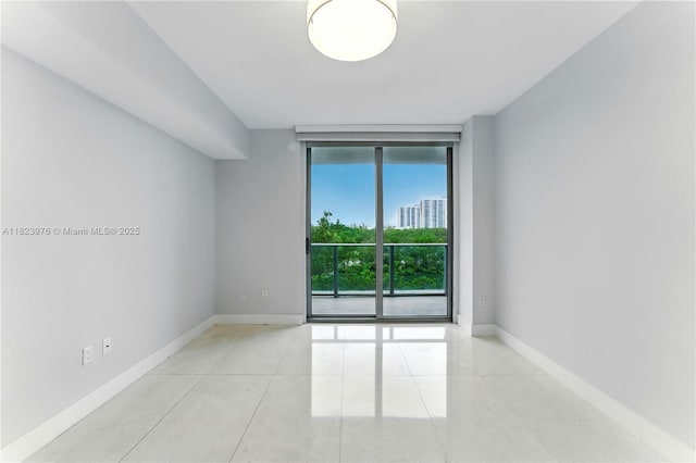 16385 Biscayne Blvd Unit 301, North Miami Beach, FL 33160 - empty room with floor to ceiling windows and tile patterned floors