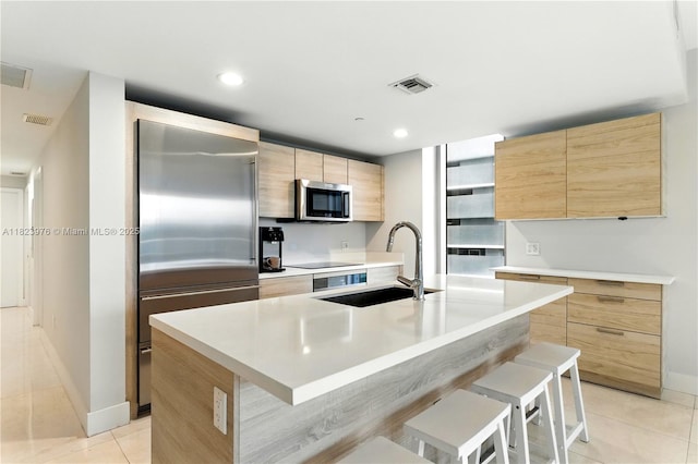16385 Biscayne Blvd Unit 301, North Miami Beach, FL 33160 - kitchen featuring stainless steel appliances, light brown cabinetry, modern cabinets, light tile patterned flooring, and recessed lighting