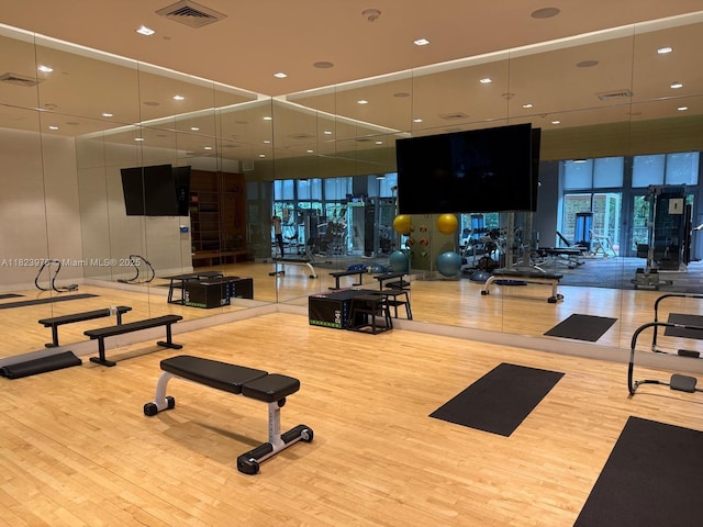 16385 Biscayne Blvd Unit 301, North Miami Beach, FL 33160 - exercise room featuring wood finished floors, a wall of windows, and recessed lighting