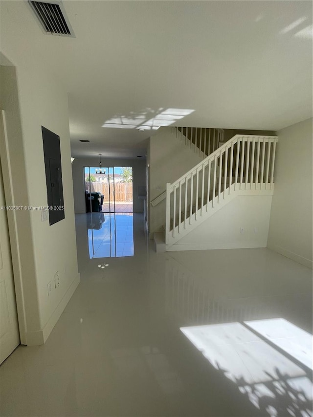 7317 NW 174th Ter Unit 102, Hialeah, FL 33015 - unfurnished living room with electric panel and stairway