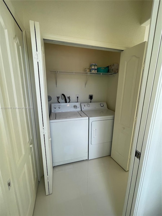 7317 NW 174th Ter Unit 102, Hialeah, FL 33015 - laundry area with washing machine and clothes dryer and light tile patterned flooring