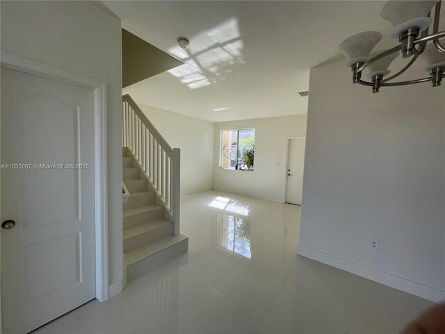 7317 NW 174th Ter Unit 102, Hialeah, FL 33015 - stairway featuring tile patterned flooring and a chandelier