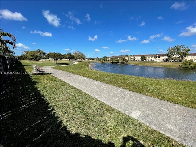 7317 NW 174th Ter Unit 102, Hialeah, FL 33015 - view of property's community featuring a water view and a lawn