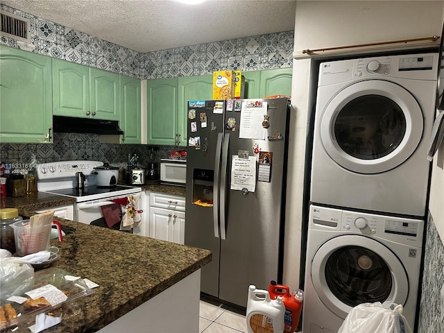 311 W Park Dr Unit 101-13, Miami, FL 33172 - kitchen featuring white appliances, under cabinet range hood, stacked washer / drying machine, dark countertops, and green cabinetry