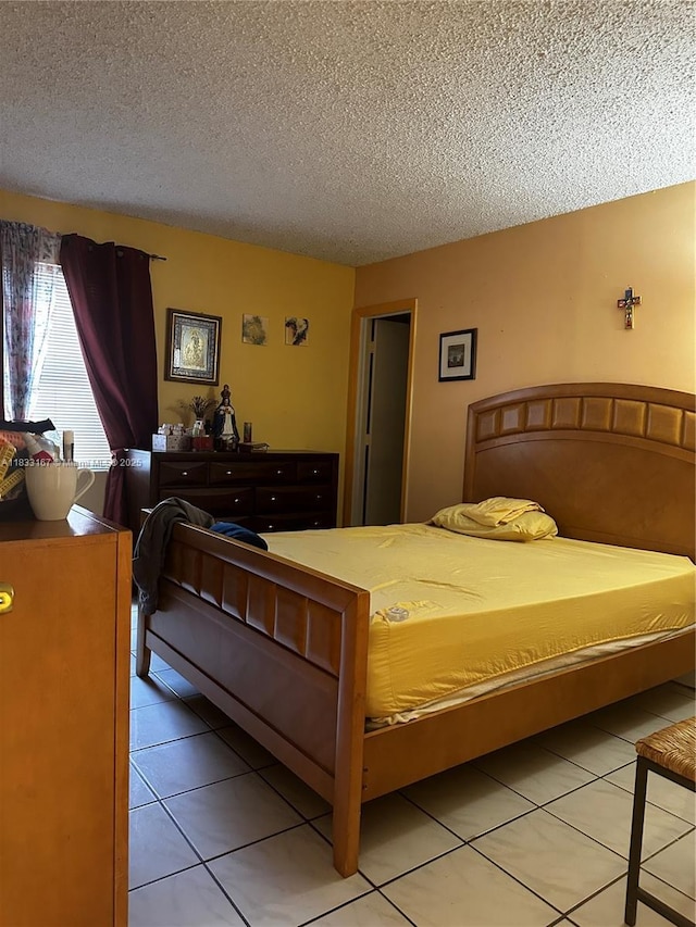 311 W Park Dr Unit 101-13, Miami, FL 33172 - bedroom with a textured ceiling and light tile patterned floors