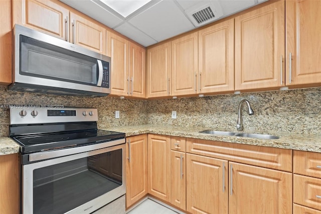 800 SW 131st Ave Unit 406F, Pembroke Pines, FL 33027 - kitchen with stainless steel appliances, light brown cabinetry, tasteful backsplash, and light stone countertops