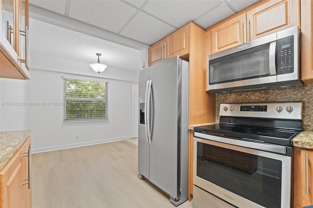 800 SW 131st Ave Unit 406F, Pembroke Pines, FL 33027 - kitchen featuring stainless steel appliances, light wood finished floors, light countertops, decorative backsplash, and light brown cabinets