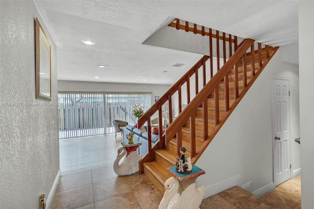 8256 NW 9th Ct Unit 2, Plantation, FL 33324 - staircase featuring tile patterned floors, recessed lighting, and a textured ceiling